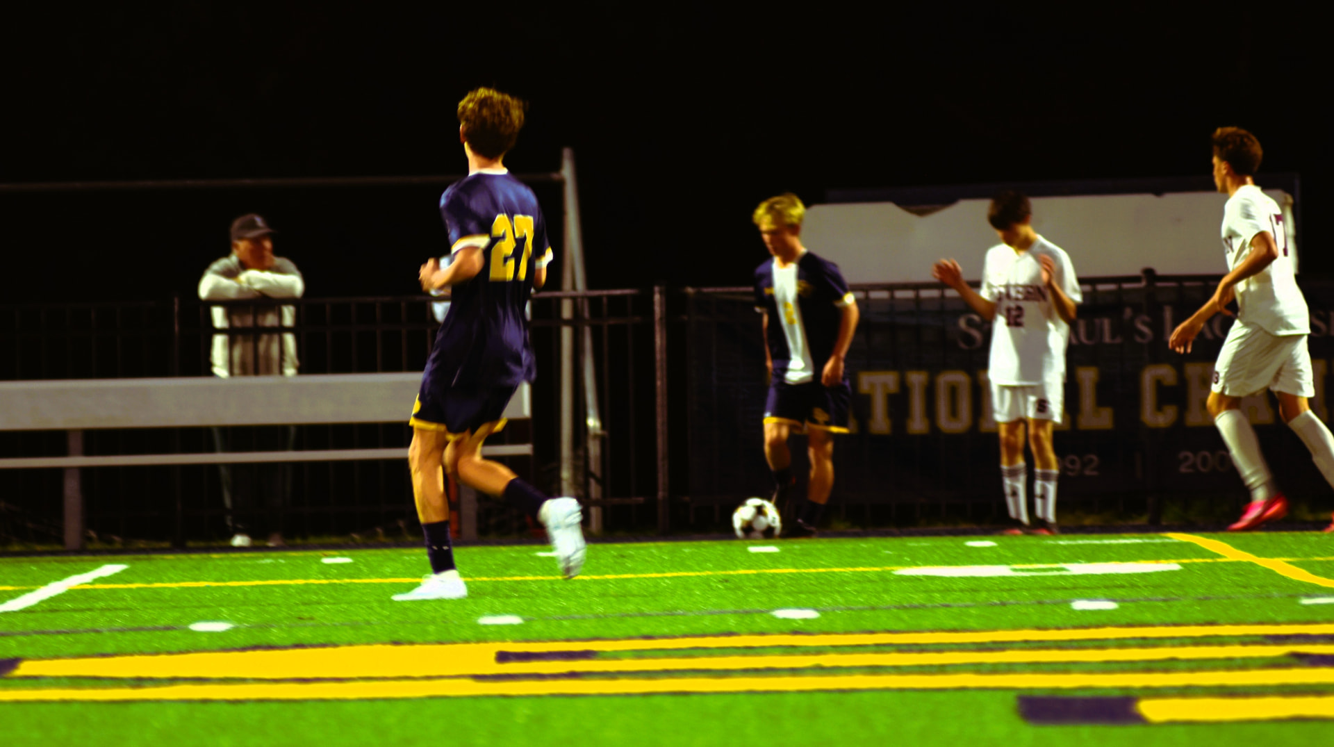 SP and Severn players near the sideline under the lights