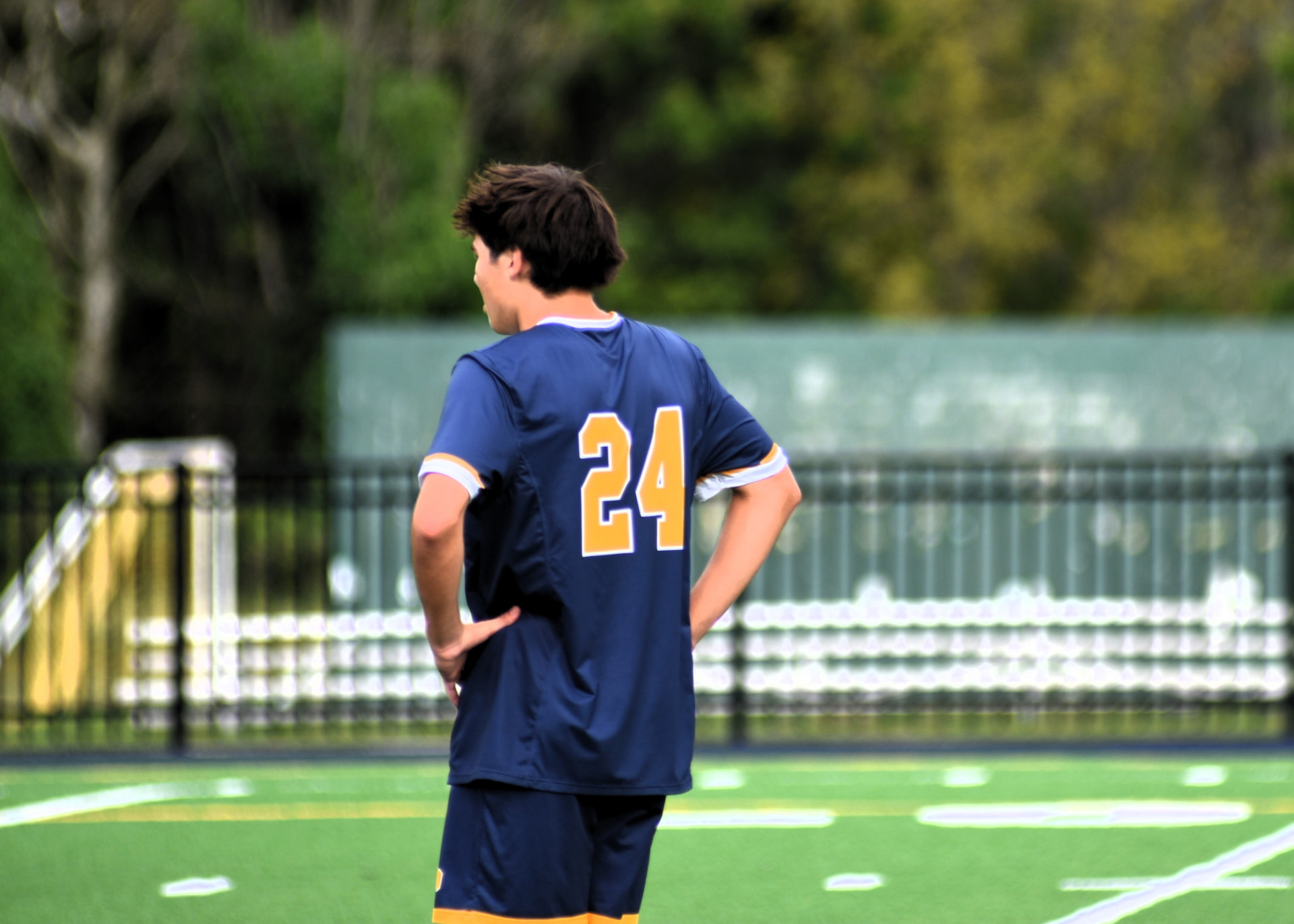 St. Paul's number 24 watches play, hands on hips