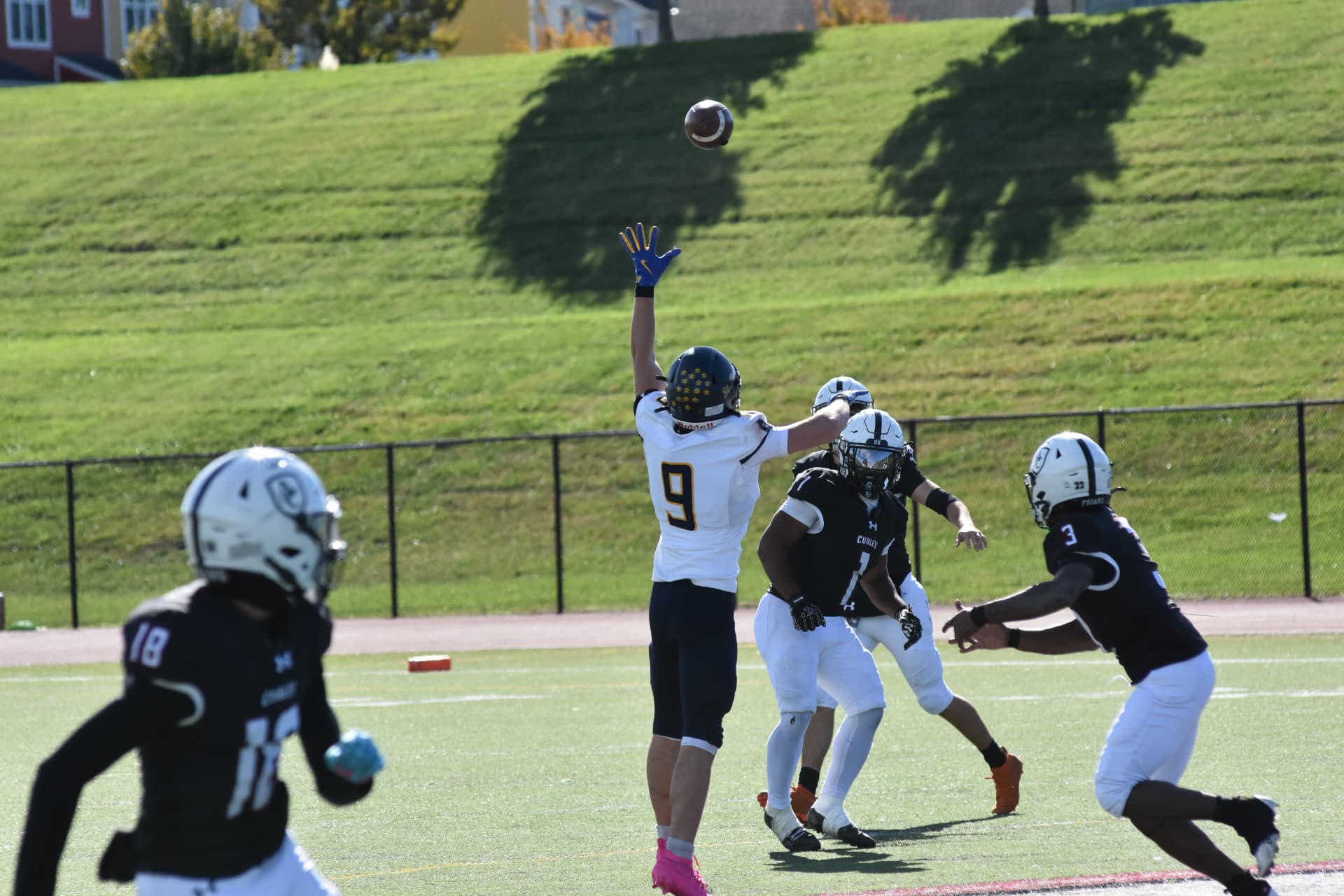 Crusaders number 9 reaches up for a pass among Curley defenders
