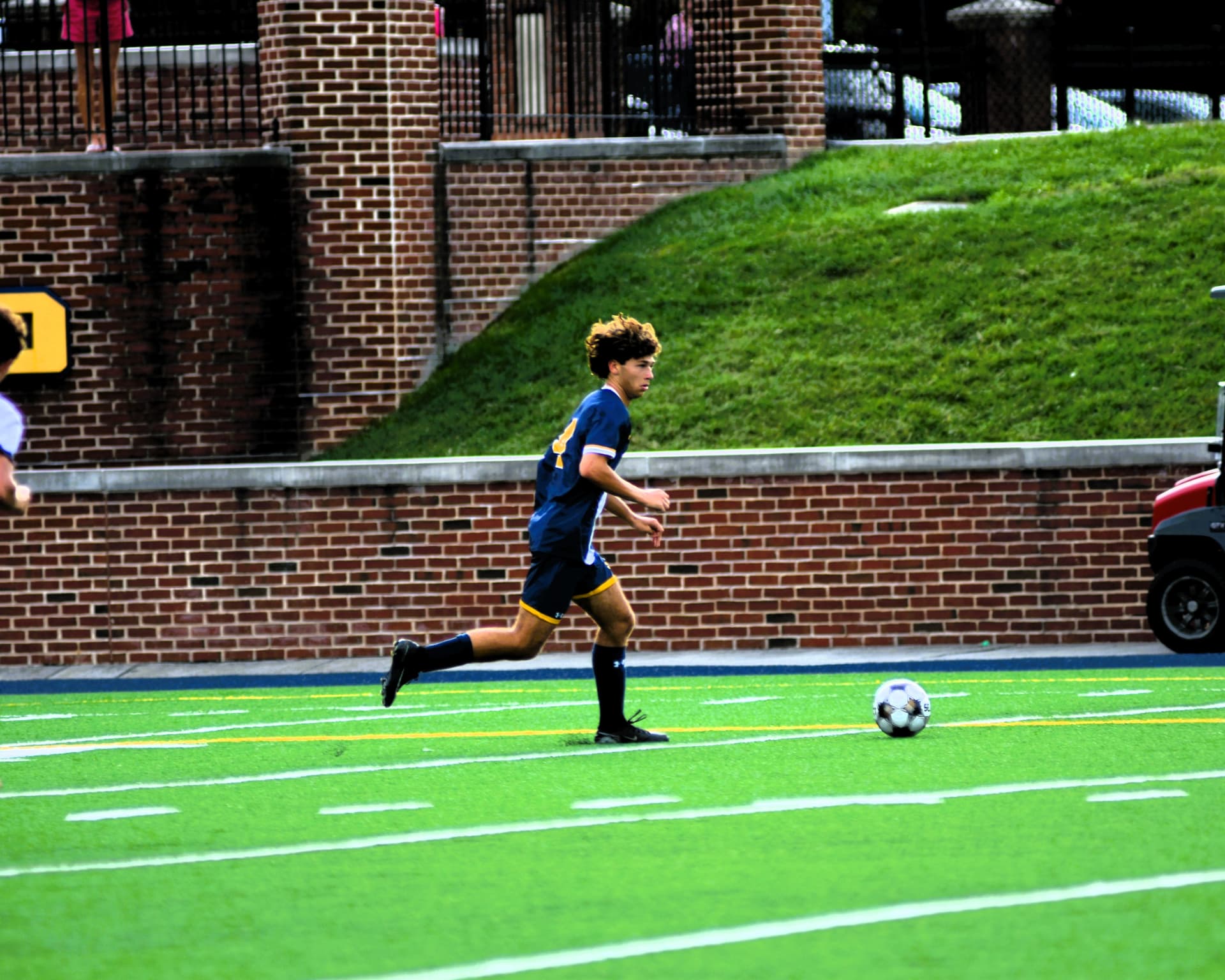 St. Paul's player carries the ball along the sideline