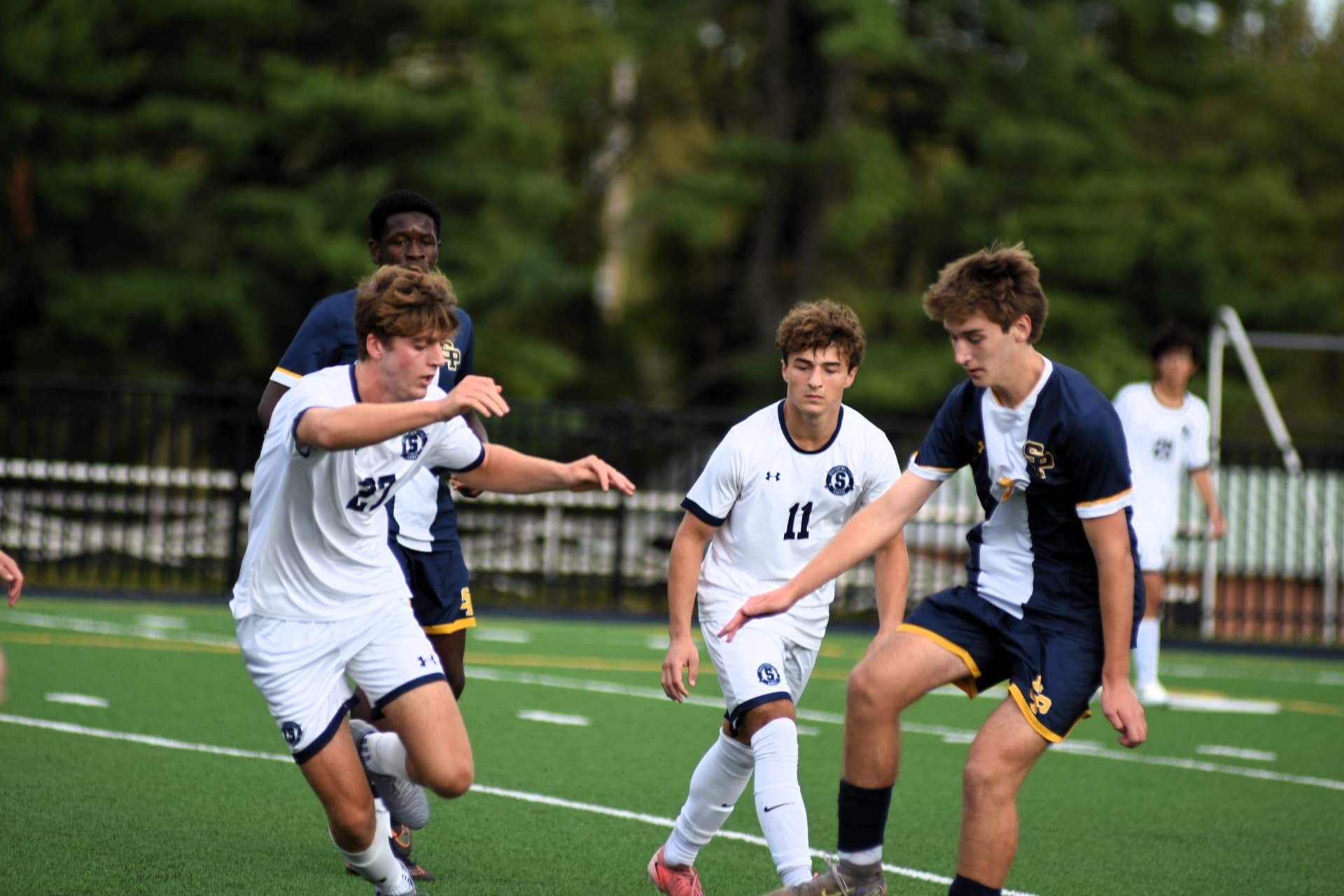 St. Paul's player shields the ball from StP&P defenders