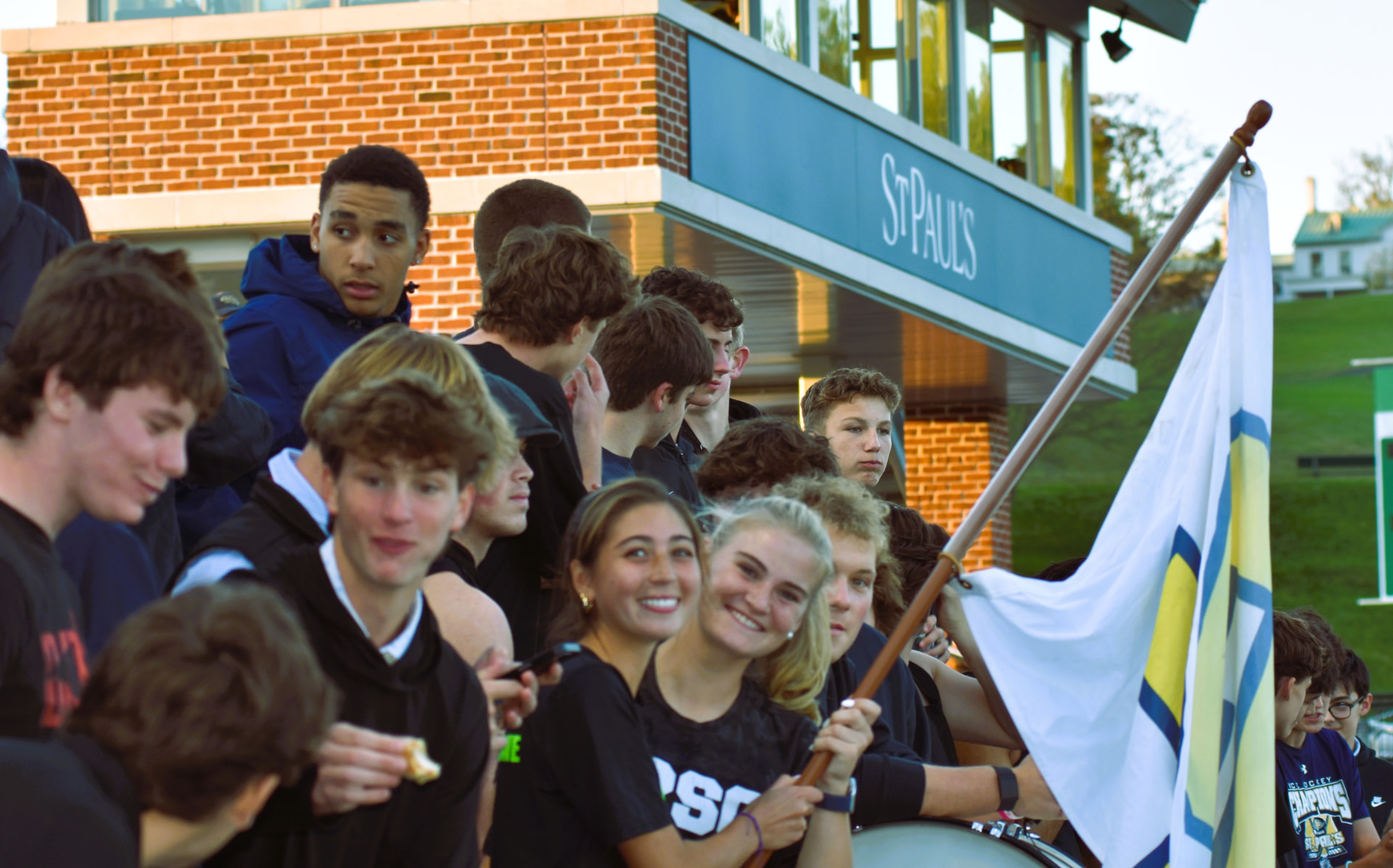 Students gather with an SP flag