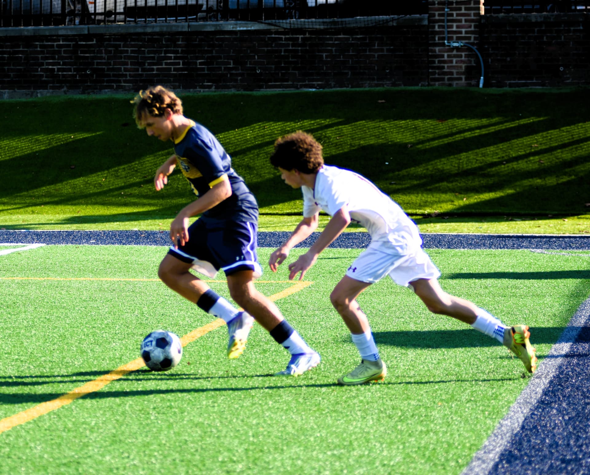 A Crusader shields the ball from a BL defender along the sideline