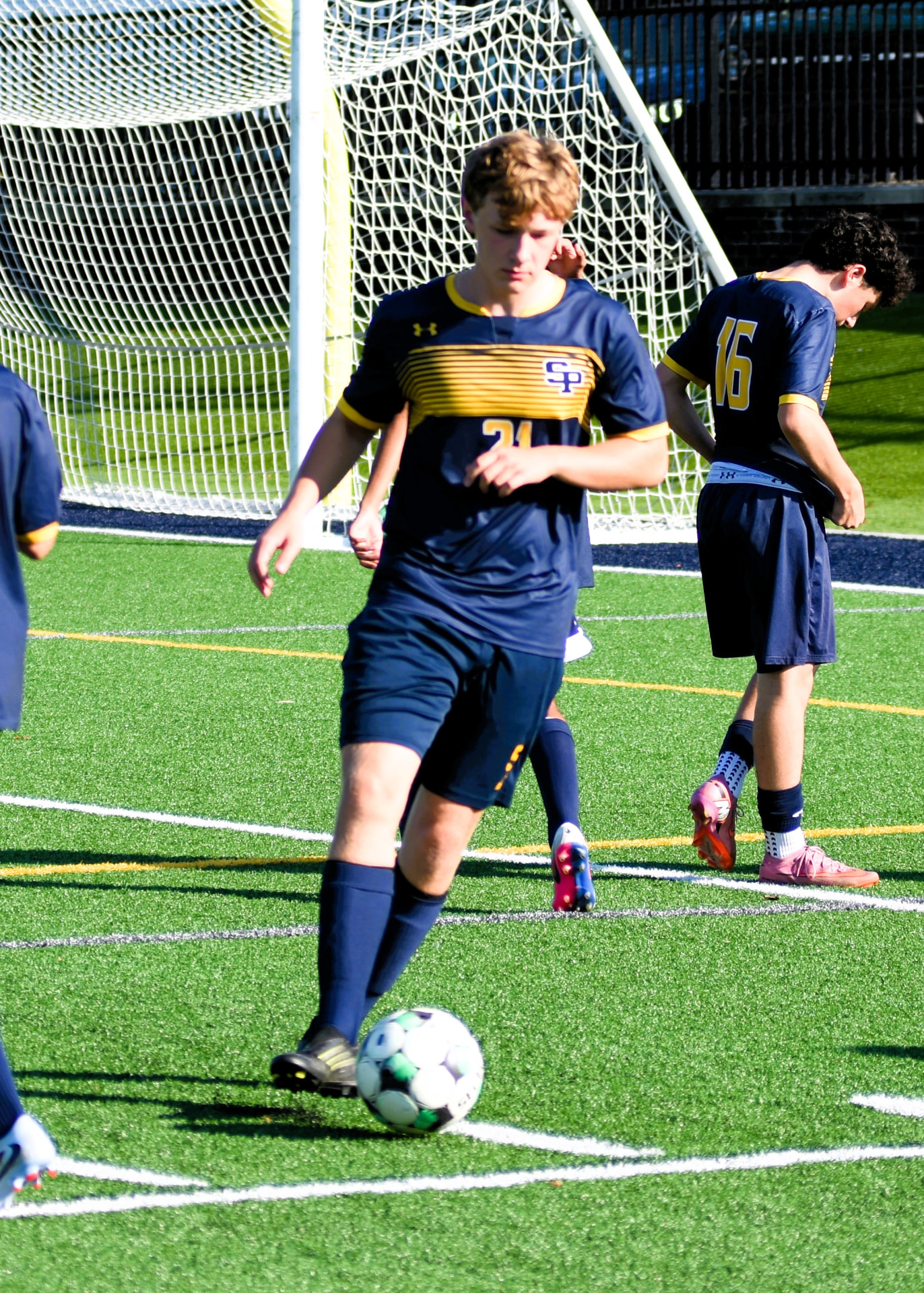 JV Crusaders number 21 plays the ball in front of the goal