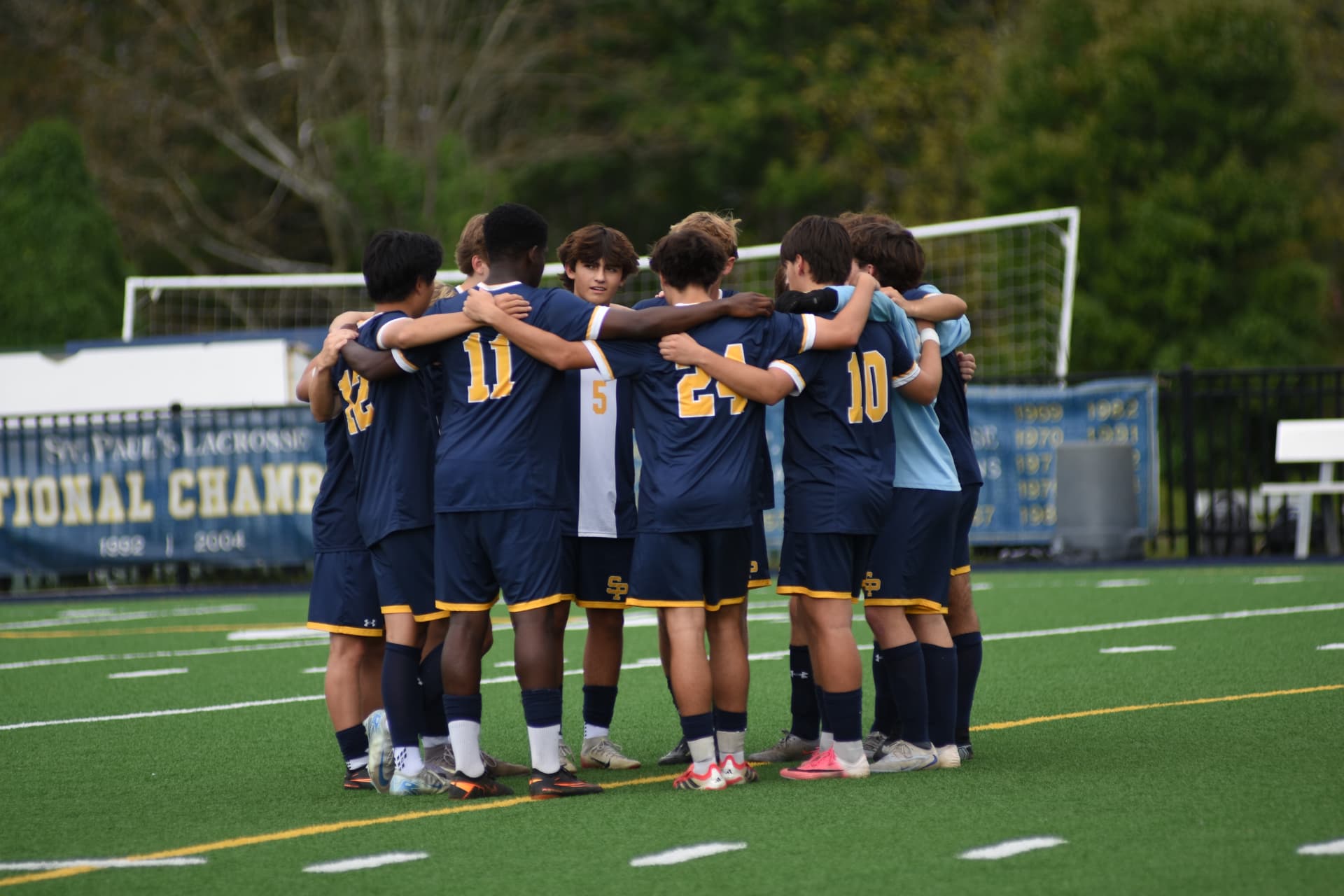 St. Paul's soccer team faces inward during its huddle