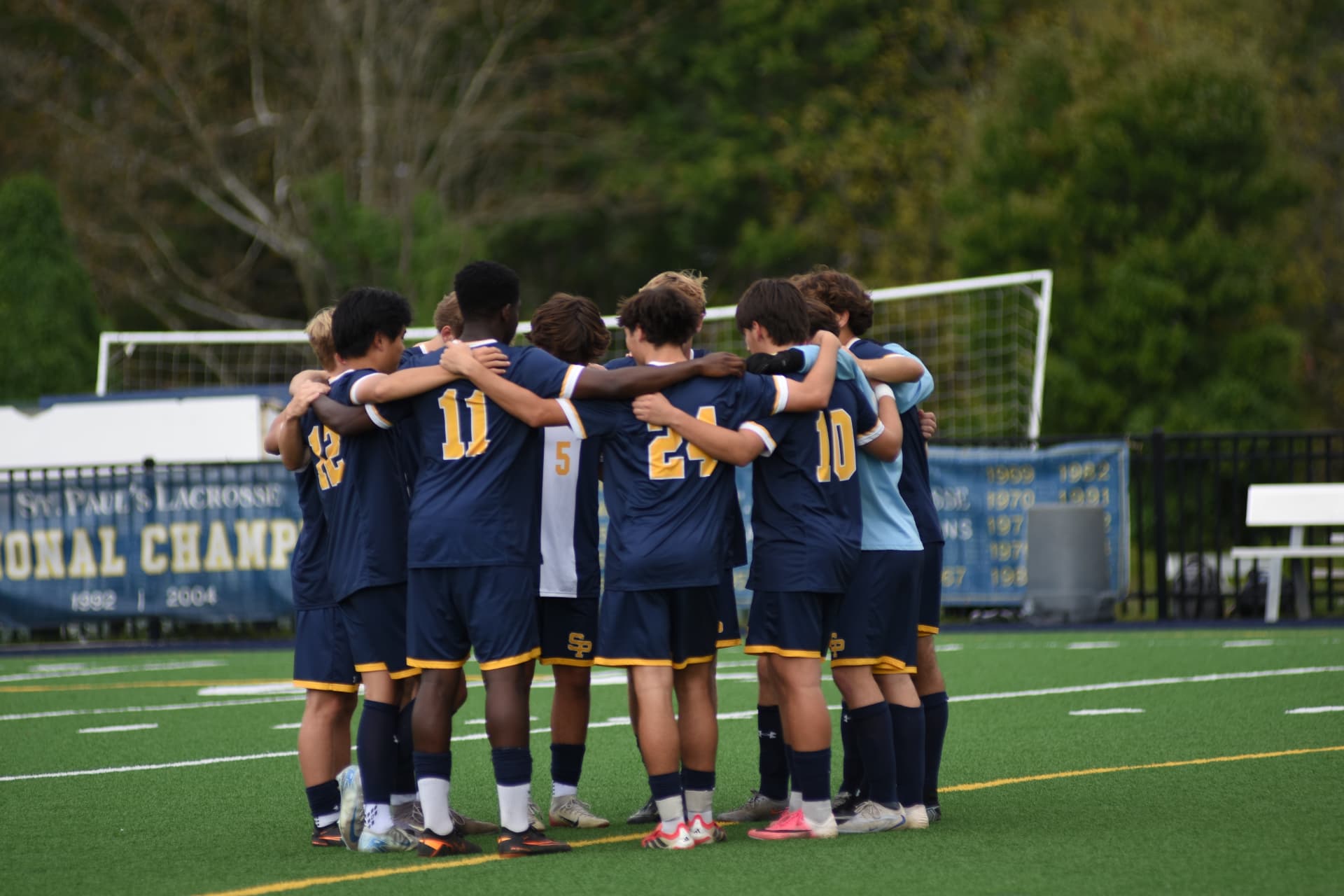 St. Paul's soccer players join a pregame huddle