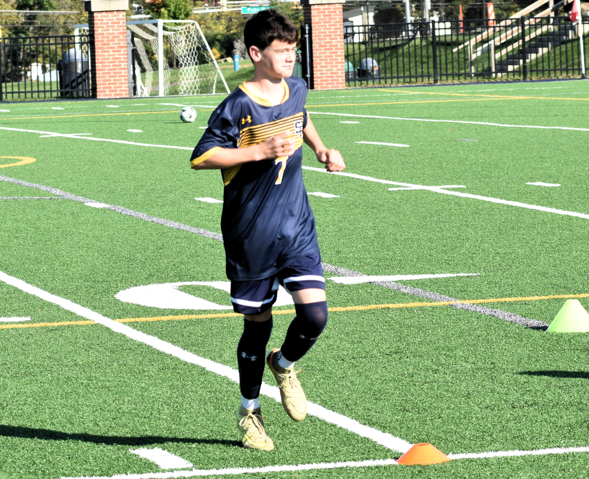 JV Crusaders number 7 jogs across the field during warmups