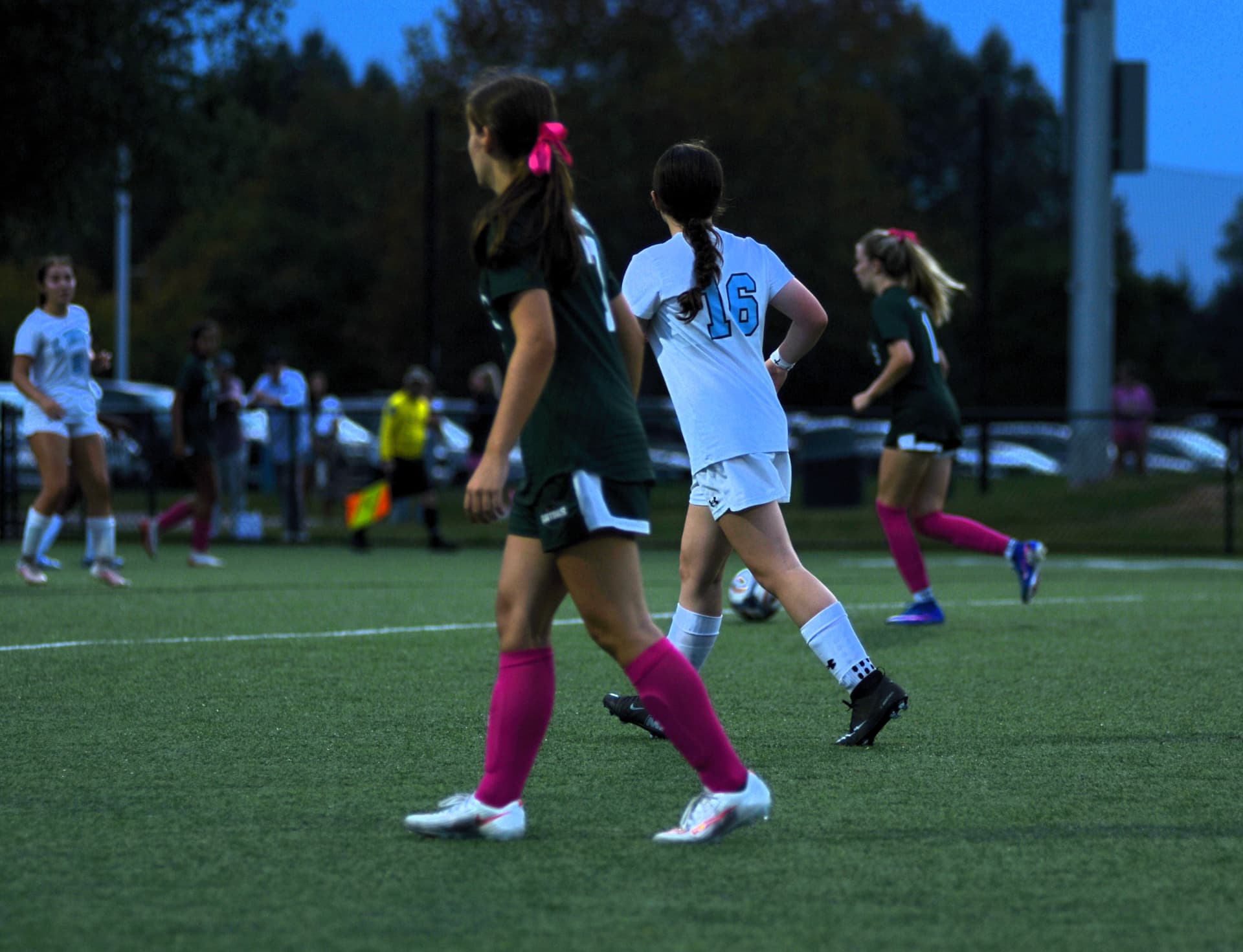 A Gators player in a pink bow tracks St. Timothy's number 16