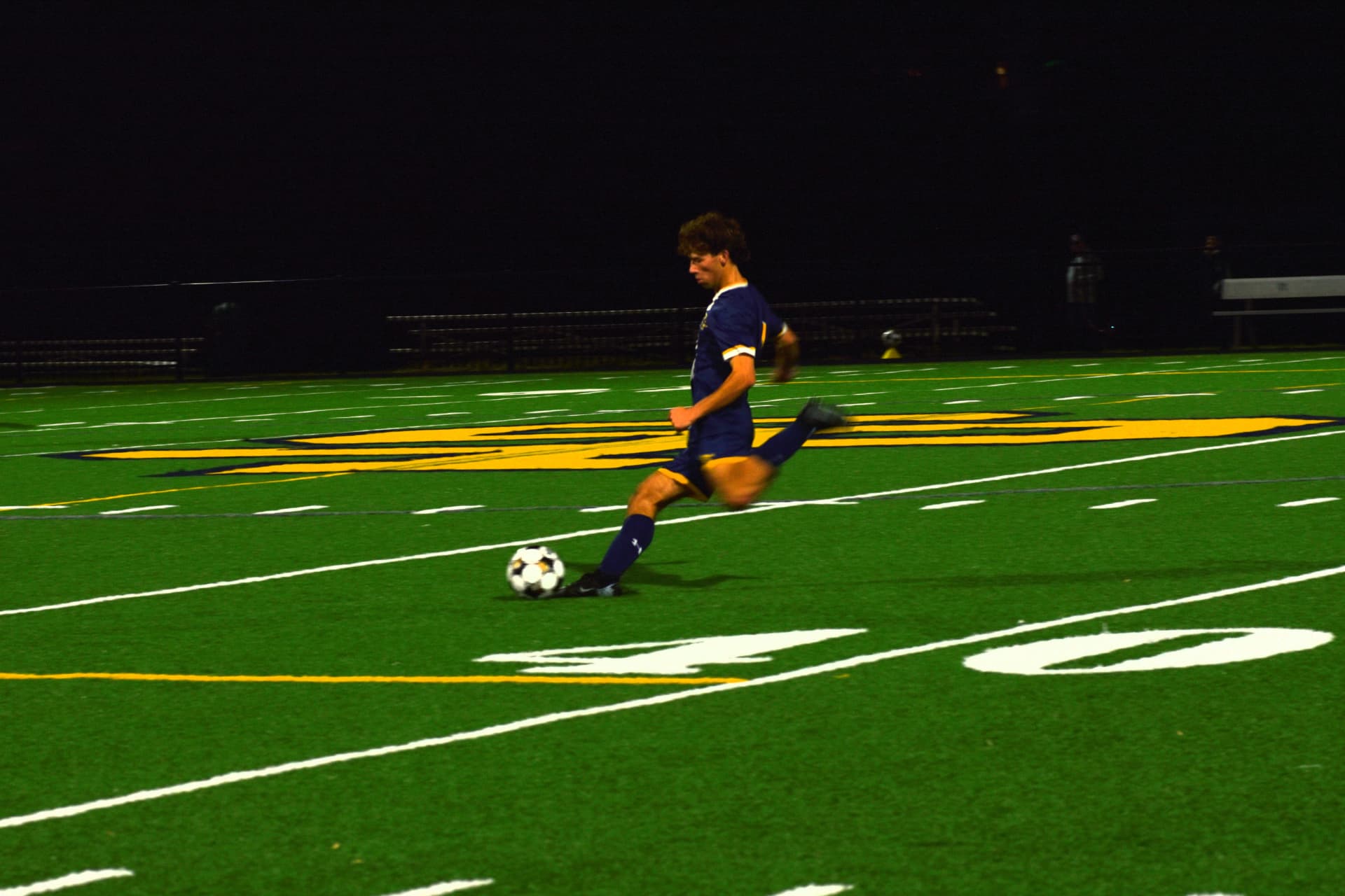 St. Paul's player strikes the ball under the lights
