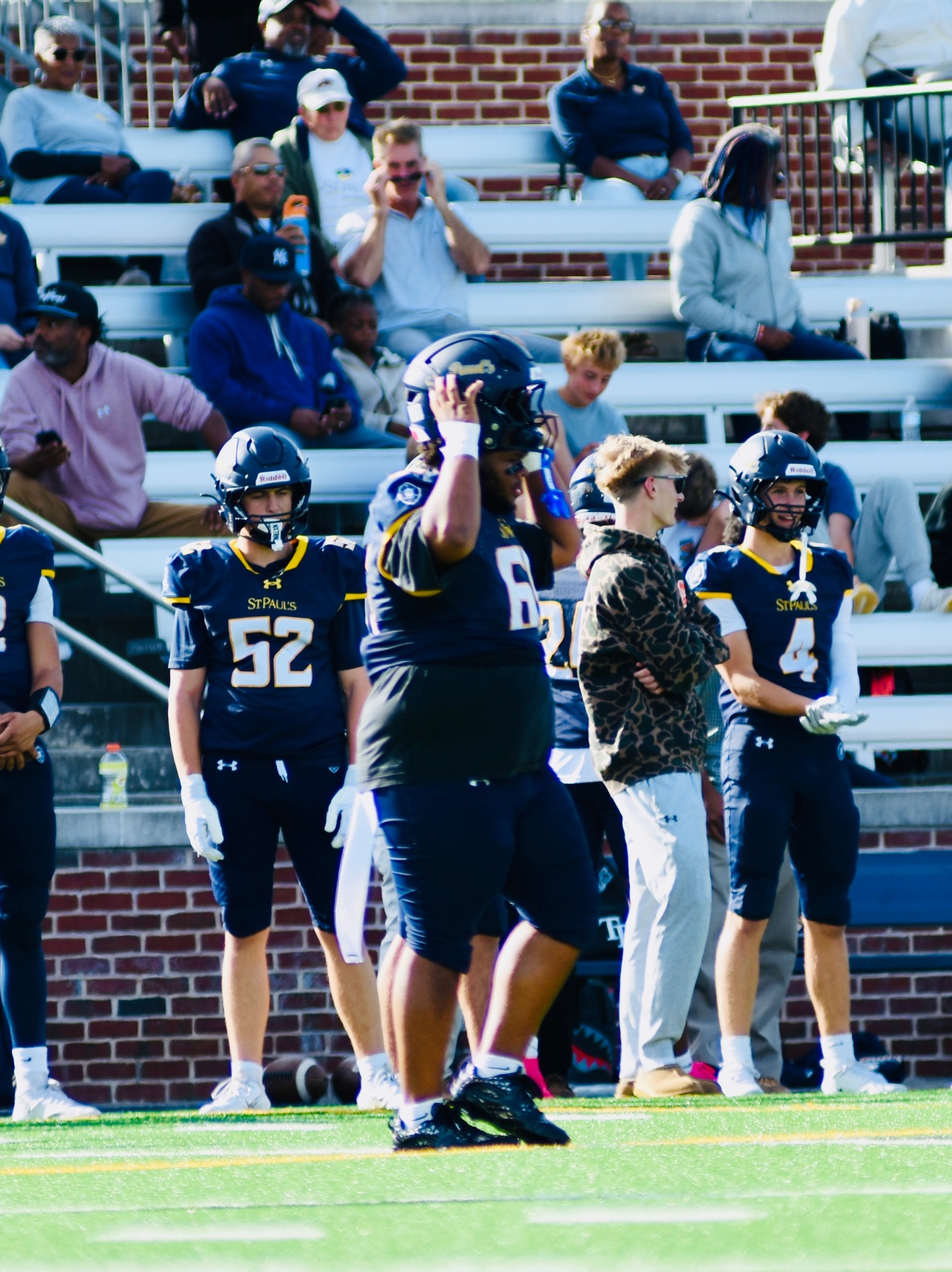 #52, #4 and teammates in front of the stands