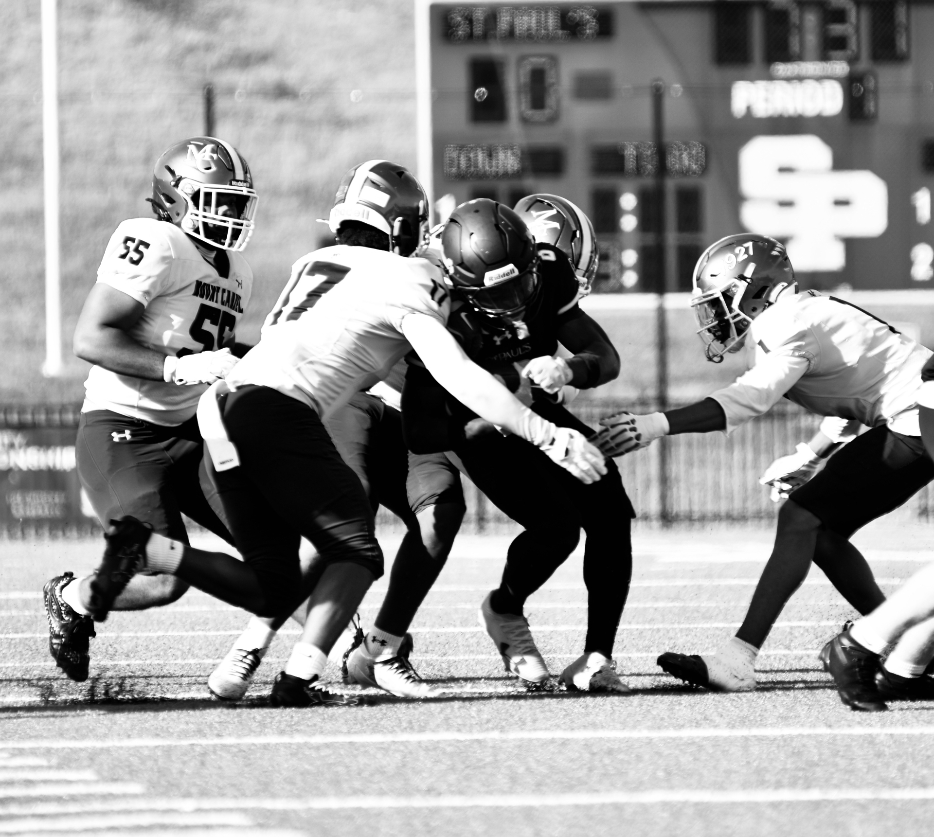 Ball carrier fighting through Mount Carmel defenders