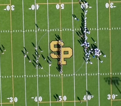Aerial view of both teams lined up at midfield